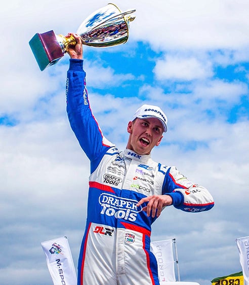 Dan Lloyd holding up his BTCC trophy