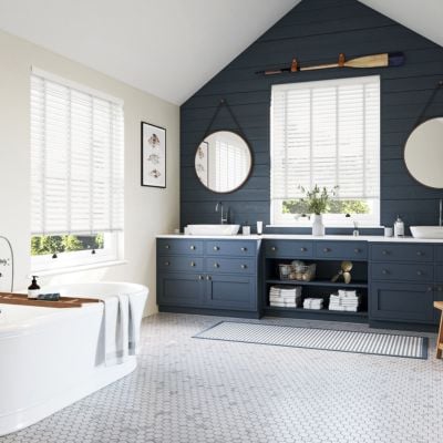 A white, wooden, taped blind in a modern, panelled bathroom 