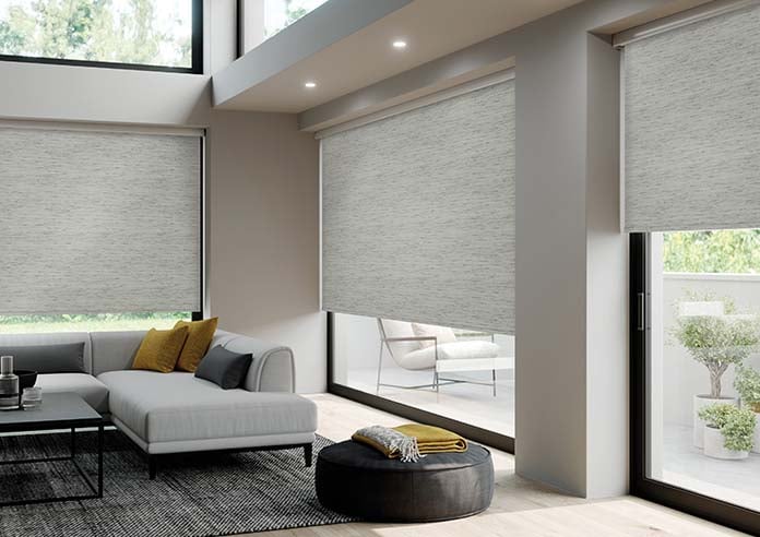 A grey textured roller blind in a living room