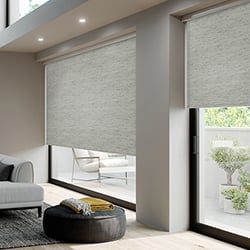 A grey textured roller blind in a living room