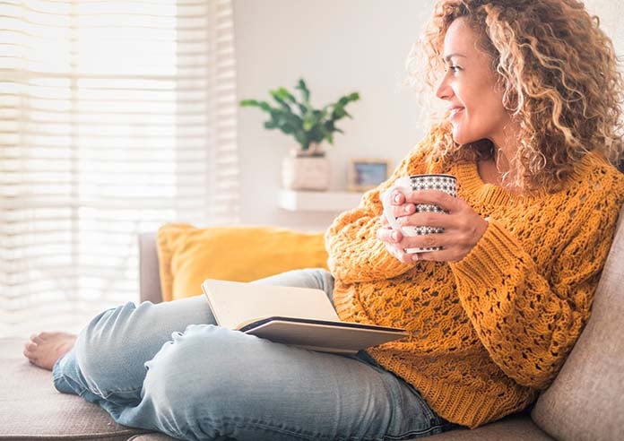 A women enjoying a brew with a book