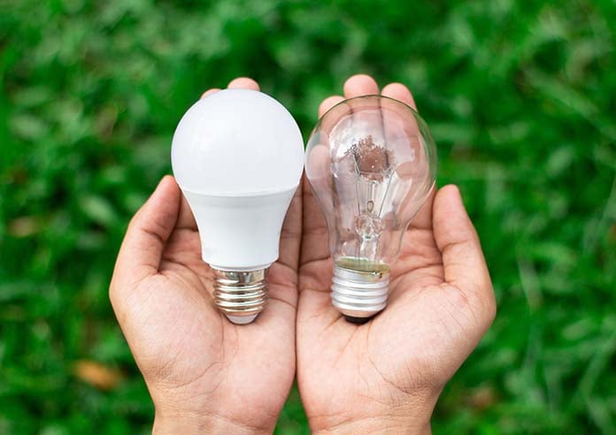 someone holding 2 different bulbs