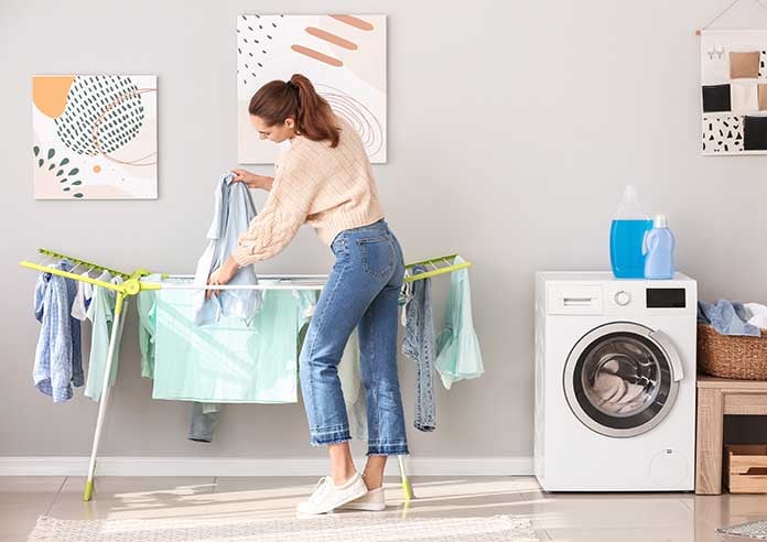 A woman doing her washing and hanging her clothes