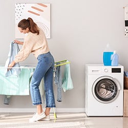 A woman doing her washing and hanging her clothes