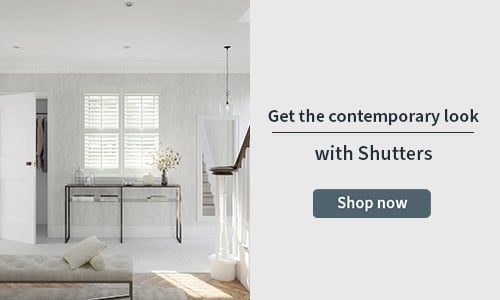 Shutter banner with a white shutter in the front window of a home