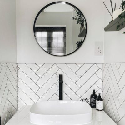 Dark, metal Venetian blinds in a bathroom window