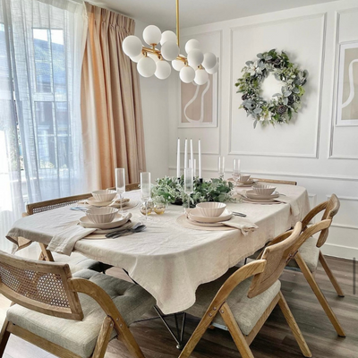 Neutral pastel Christmassy dining room with peach floor-to-ceiling curtains