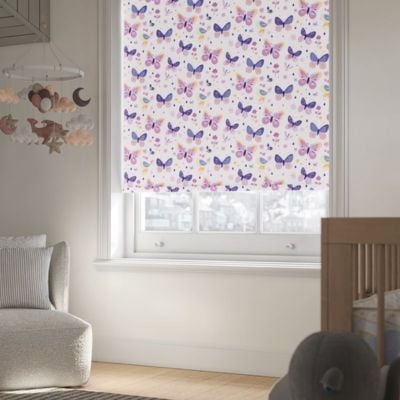 A white roller blind with purple and pink cartoon butterflies in a nursery 