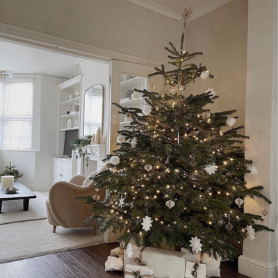 Scandi neutral minimalist Christmas tree with white and beige paper ornaments.