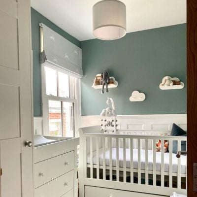 A grey and beige bedroom with a grey roman blind