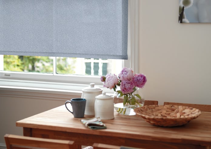 Blue patterned roller blind in a dining room