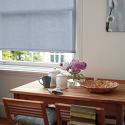 Blue patterned roller blind in a dining room