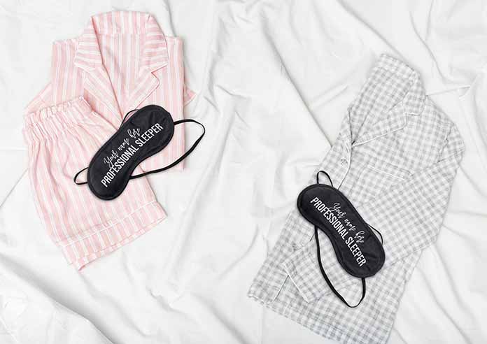 Pyjamas on a bed with sleep masks on top