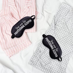 Pyjamas on a bed with sleep masks on top