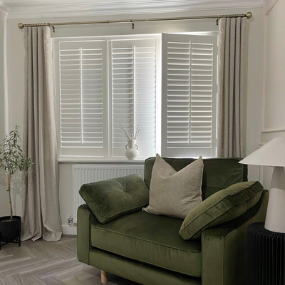 White modern bedroom with a white motorised blackout roller blind. 