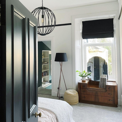 Mid-century modern style bedroom with a black Roman blind.
